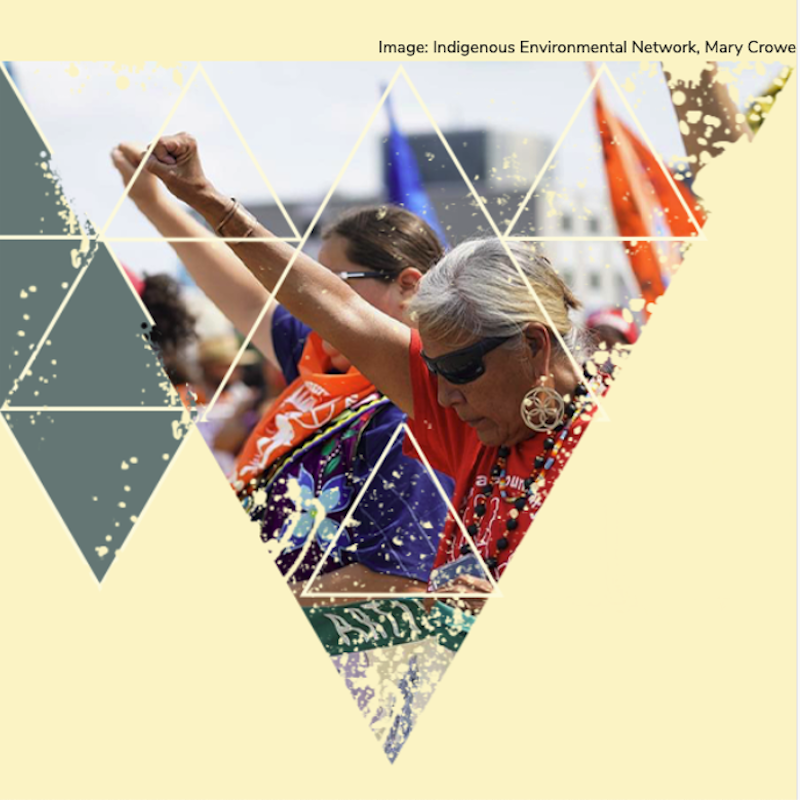 People with head bowed and fist in the air